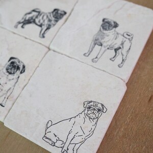May include: Set of four white ceramic coasters with black line drawings of pugs. Each coaster features a different pose of a pug.