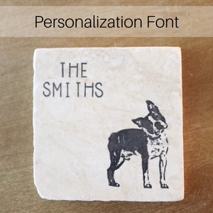 May include: A square, off-white stone coaster with the text "THE SMITHS" in black, block letters. A black and white Boston Terrier dog illustration is below the text. The words "Personalization Font" are above the coaster.