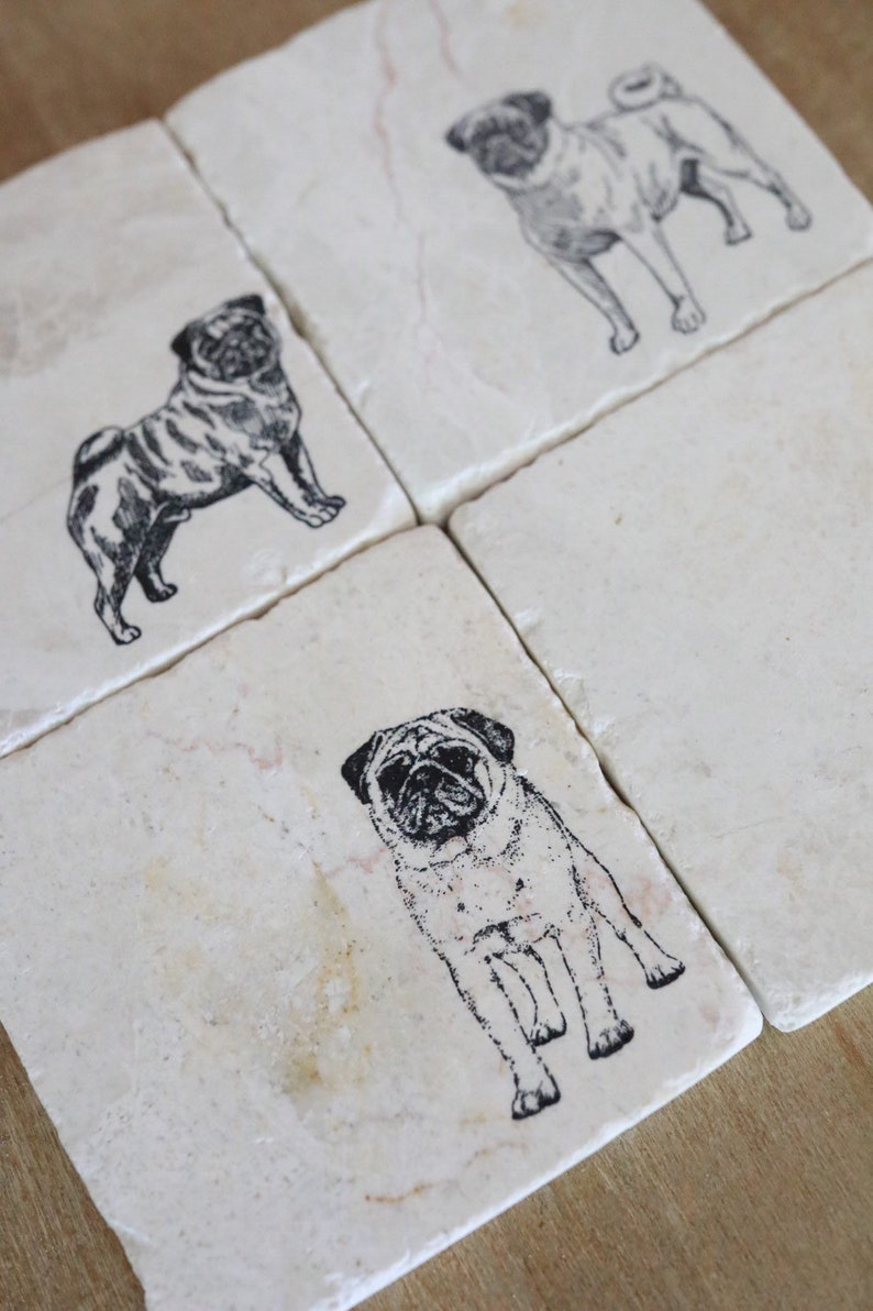 May include: Four white square coasters with black pug dog illustrations. The coasters are made of marble and have a natural, rustic look.