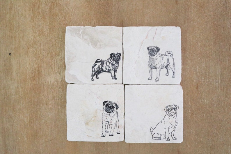 May include: Set of four white stone coasters with black pug dog illustrations. Each coaster features a different pug pose.