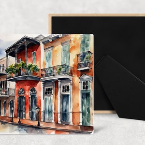 May include: Watercolor painting of colorful buildings with balconies and wrought iron railings. The buildings are painted in shades of red, orange, yellow, and green. The painting is set against a light blue sky.