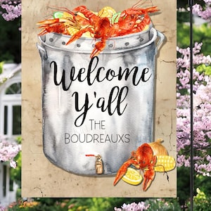 May include: A welcome sign with a pot of crawfish and the text "Welcome y'all The BOUDREAUXS".