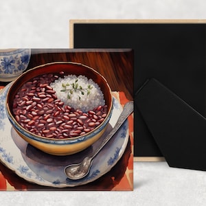 May include: A close-up of a bowl of red beans and rice. The bowl is on a white and blue patterned plate. The plate is on a red and orange patterned surface.