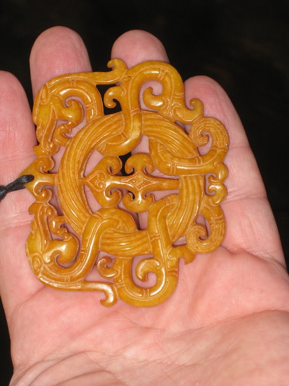 All natural jade hand carved two sided dragon pendant, with adjustable necklace.