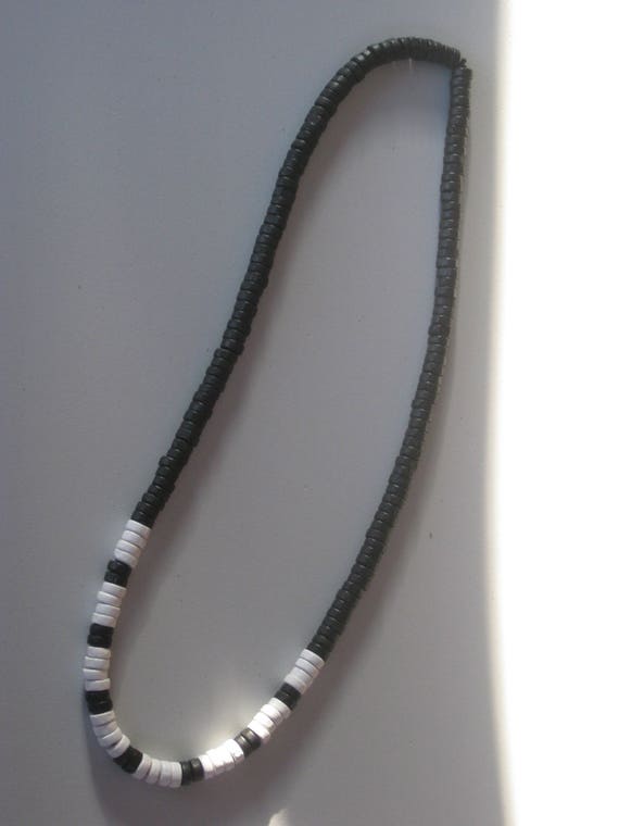 Hand carved natural Wood bead surfer necklace.