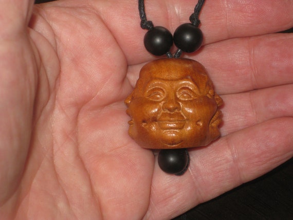 Hand carved 4 sided rosewood pendant with 4 faces.