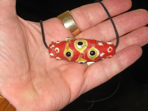 Hand made glazed organic cinnibar pendant with 29 eyes.