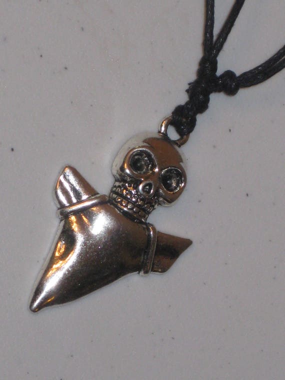 Skull and shark tooth pendant necklace.