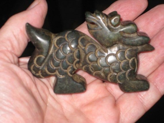 All natural hand carved two sided Jade baby dragon statue.
