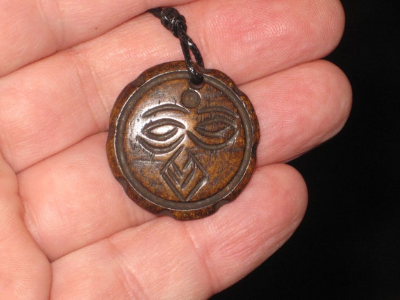 Buffalo bone sun face, hand carved pendant.