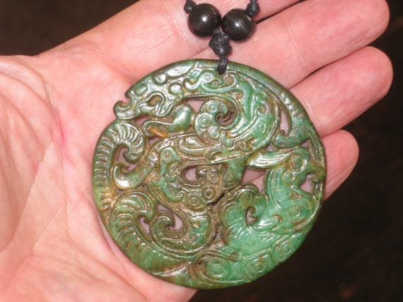 All natural hand carved two sided Jade dragon pendant, with adjustable necklace.