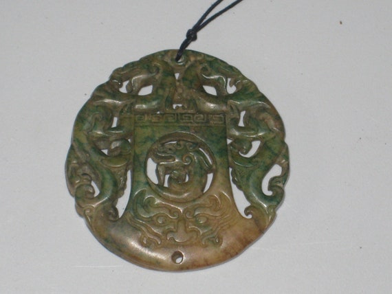 All natural hand carved two sided Jade dragon pendant, with adjustable necklace.