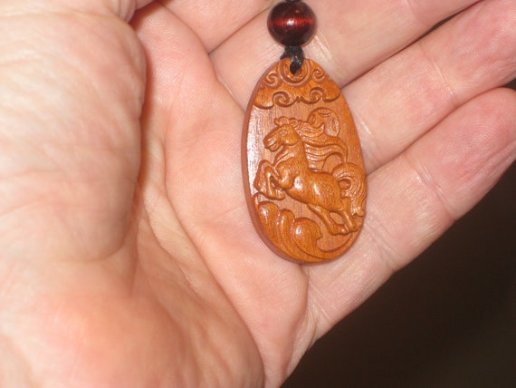 Hand carved Chinese Zodiac sign rosewood necklace (horse), 24" long.