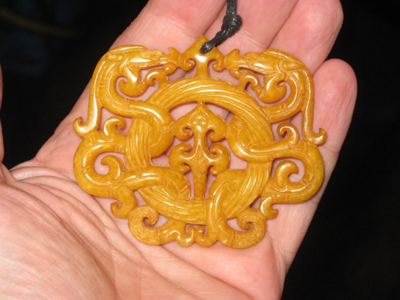 All natural jade hand carved two sided dragon pendant, with adjustable necklace.