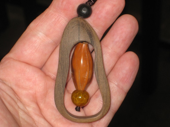 Hand carved Sandalwood pendant, with adjustable necklace.