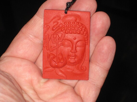 Organic Cinnabar buddha pendant, with adjustable necklace.