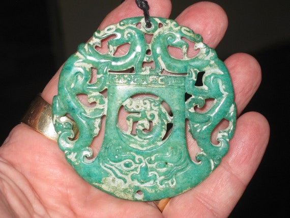 All natural hand carved two sided Jade dragon pendant, with adjustable necklace.