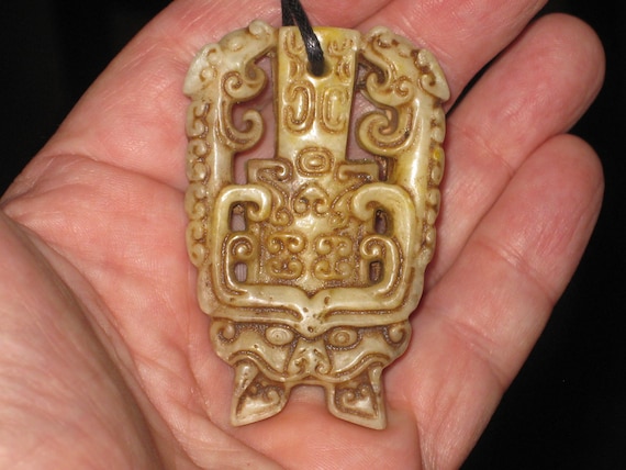 All natural jade hand carved two sided dragon and beast pendant, with adjustable necklace.