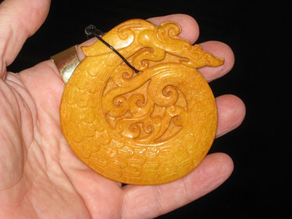 All natural hand carved Jade dragon pendant, with adjustable necklace.