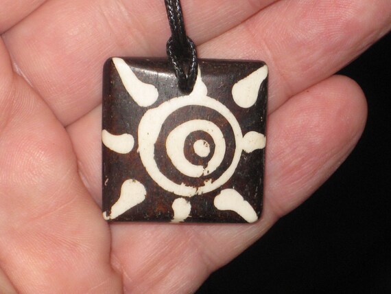 Buffalo bone African tribal sun, hand carved pendant.