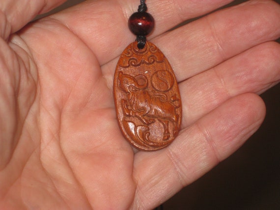 Hand carved Chinese Zodiac sign rosewood necklace (Ox), 24" long.