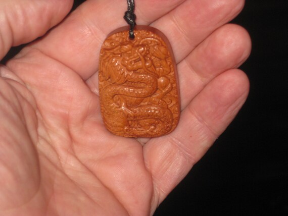 Hand carved rosewood dragon pendant.