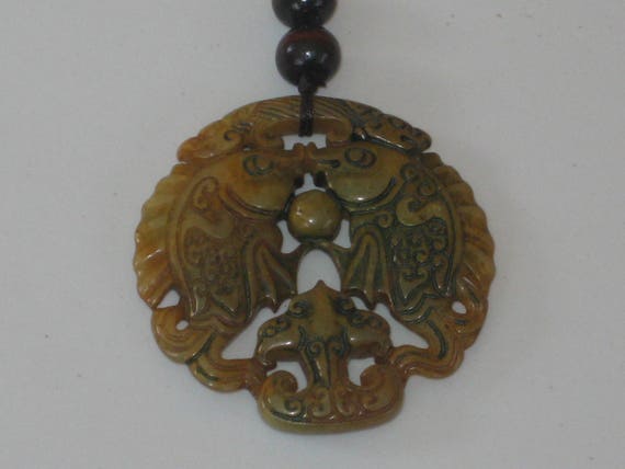 All natural hand carved two sided Jade fish pendant, with adjustable necklace.