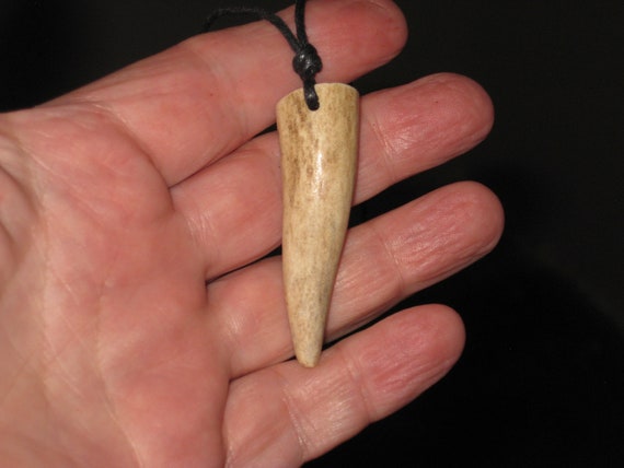 All natural deer antler tip, with adjustable necklace.