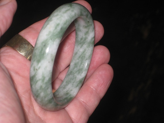 Hand carved green jade bangle, centre is 60mm.