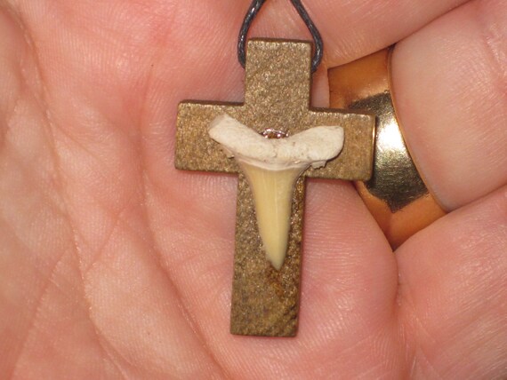 Hand carved wood cross pendant with fossilized shark tooth.
