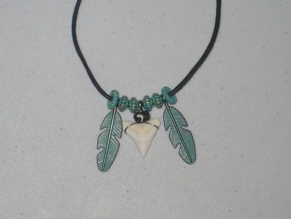 Real shark tooth and feather pendant, with adjustable necklace.