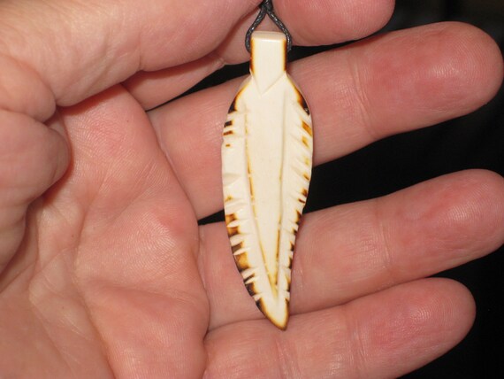 Buffalo bone hand carved feather pendant.