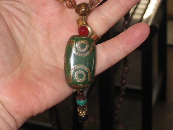 Hand carved Sandalwood pendant with stone beads and pendant.