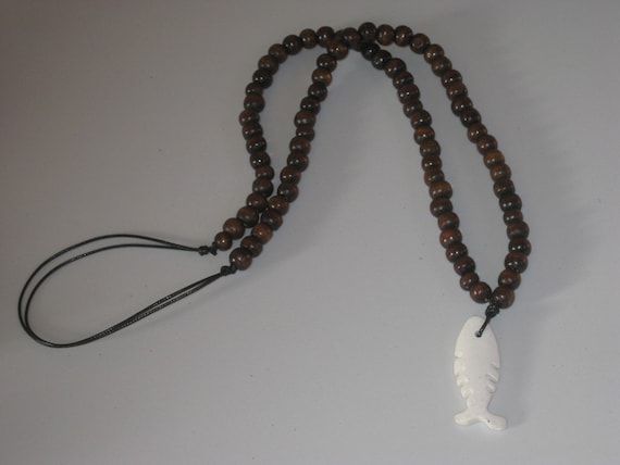 Hand carved buffalo bone pendant and wood beads from Africa.