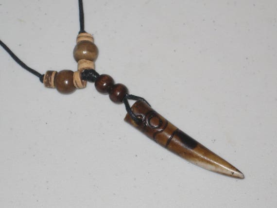 Hand carved Bone primitive tooth.