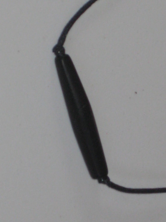 Hand carved bone tube pendant, with adjustable necklace.