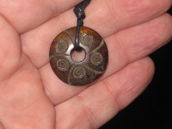 Buffalo bone hand carved flower pendant.