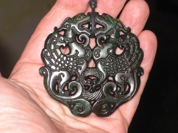 All natural dark black green jade hand carved two sided dragon pendant.