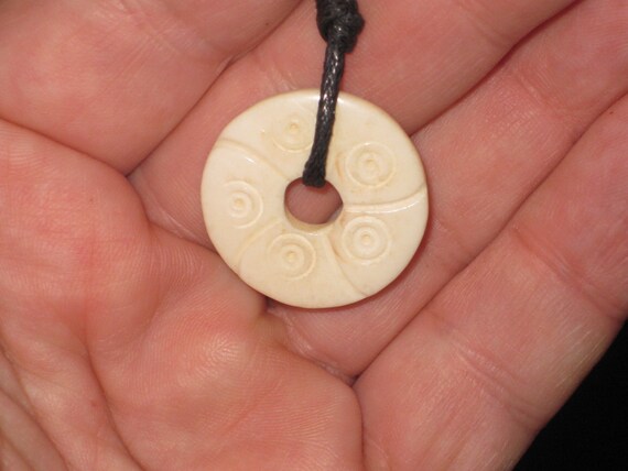 Buffalo bone hand carved flower pendant.
