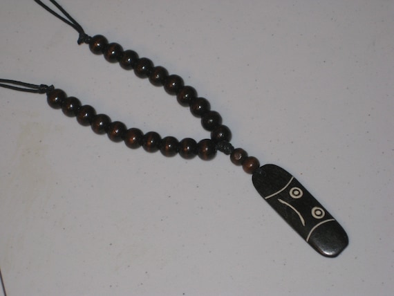 Buffalo bone pendant and wood beads, with adjustable necklace.