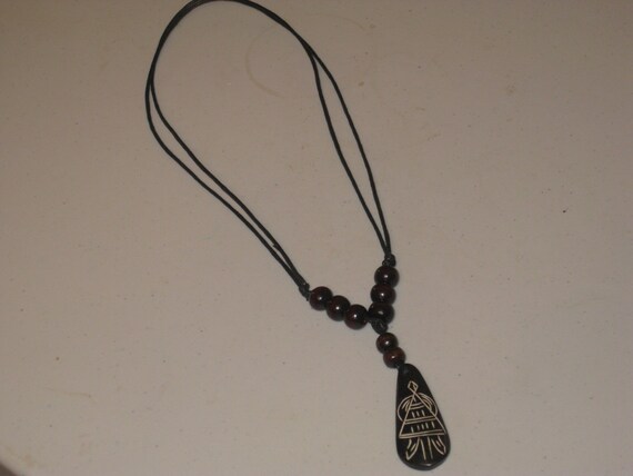 Hand carved African design buffalo bone pendant, adjustable necklace.