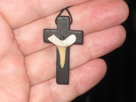 Hand carved wood cross pendant with fossilized shark tooth.