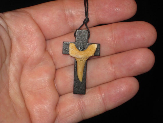 Hand carved wood cross and fossil shark tooth from Morocco, with adjustable necklace.