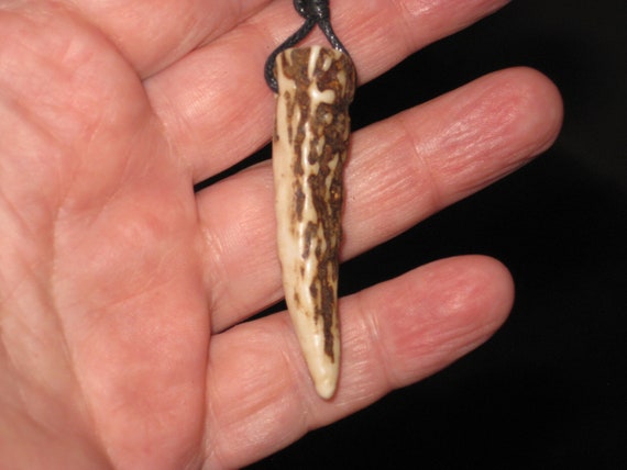 All natural deer antler tip, with adjustable necklace.