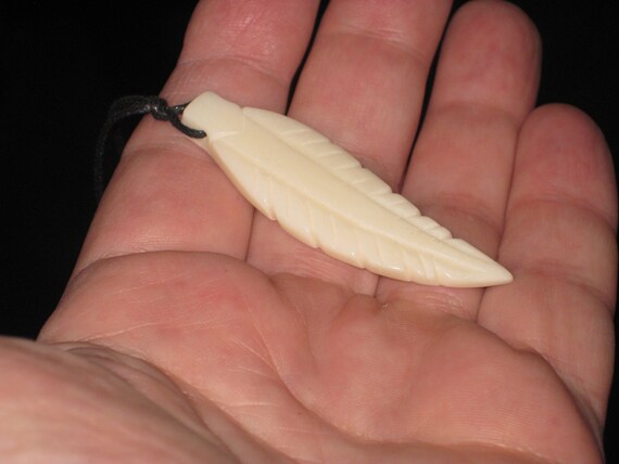 Buffalo bone hand carved feather pendant.