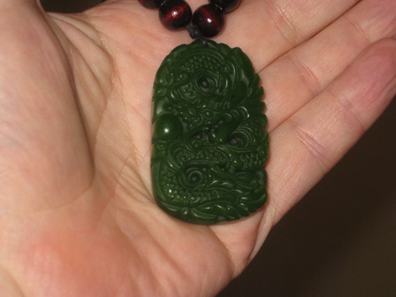 All natural hand carved grade A jade dragon amulet.
