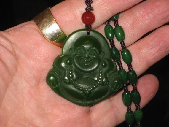 All natural hand carved Jade Buddha pendant, with jade beads 22" long.