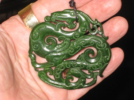 All natural hand carved two sided Jade dragon pendant.