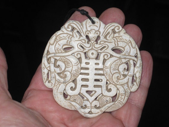 All natural jade hand carved two sided dragon pendant, with adjustable necklace.