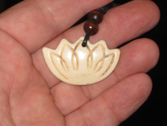 Buffalo bone hand carved lotus blossom pendant.